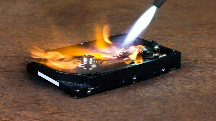 photo of disk drive being destroyed by blowtorch