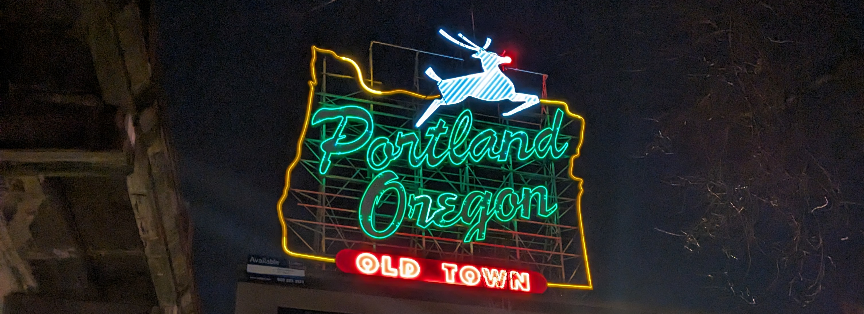 The Portland 'White Stag' sign, lit up with a red nose for the holiday.